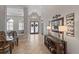 Inviting entryway with tile flooring, decorative console table and frosted glass double doors at 3852 Brantley Place Cir, Apopka, FL 32703