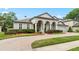 Stately home with a manicured lawn, mature landscaping, and a brick-paved driveway at 3852 Brantley Place Cir, Apopka, FL 32703