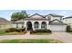 Charming home featuring a beautiful brick driveway, well-manicured landscaping, and a two-car garage at 3852 Brantley Place Cir, Apopka, FL 32703