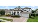 Charming home featuring a beautiful brick driveway, well-manicured landscaping, and a two-car garage at 3852 Brantley Place Cir, Apopka, FL 32703