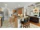 Open kitchen with a breakfast bar, stainless appliances, and seamless flow to the living area at 3852 Brantley Place Cir, Apopka, FL 32703