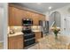 Kitchen boasts stainless appliances, granite counters and wood cabinetry at 3852 Brantley Place Cir, Apopka, FL 32703