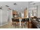 Kitchen island with barstool seating and natural-wood cabinetry and hardware at 3852 Brantley Place Cir, Apopka, FL 32703