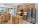 Spacious kitchen featuring an island, granite countertops, wooden cabinets and stainless-steel appliances at 3852 Brantley Place Cir, Apopka, FL 32703