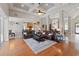 Spacious living room with wood floors, coffered ceilings, columns, leather furniture, and an open layout at 3852 Brantley Place Cir, Apopka, FL 32703