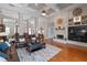 Open living room with brick fireplace, coffered ceilings and hardwood floors at 3852 Brantley Place Cir, Apopka, FL 32703