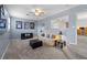 A relaxing living area featuring a comfy sofa, TV, and neutral tones with a ceiling fan at 3852 Brantley Place Cir, Apopka, FL 32703