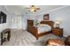 Spacious primary bedroom with a large bed, wooden furniture, and neutral color palette, providing a serene retreat at 3852 Brantley Place Cir, Apopka, FL 32703