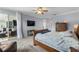 Spacious main bedroom features a ceiling fan, television, and access to the outdoor living area at 3852 Brantley Place Cir, Apopka, FL 32703