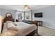 Main bedroom featuring a large bed, dresser, mounted television, and backyard pool views at 3852 Brantley Place Cir, Apopka, FL 32703