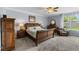 Main bedroom with a carpet, wood bed and furniture, ceiling fan, and blue wall paint at 3852 Brantley Place Cir, Apopka, FL 32703