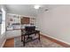 Bright home office with custom built-ins and a ceiling fan with hardwood flooring and a patterned rug at 3852 Brantley Place Cir, Apopka, FL 32703