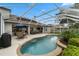 Backyard pool, patio, and outdoor dining underneath a screened enclosure at 3852 Brantley Place Cir, Apopka, FL 32703