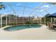 Refreshing pool with a screened enclosure, featuring a waterfall and patio area for outdoor relaxation and enjoyment at 3852 Brantley Place Cir, Apopka, FL 32703