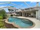 Outdoor pool area featuring a covered patio, ample seating, lush landscaping, and screened enclosure at 3852 Brantley Place Cir, Apopka, FL 32703