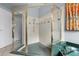 Elegant shower with glass enclosure, green marble accents, and modern fixtures at 3852 Brantley Place Cir, Apopka, FL 32703