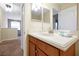 Bathroom with wood cabinet vanity, white countertop, and sink with faucet and mirror at 8904 Candy Palm Rd, Kissimmee, FL 34747