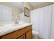 Bathroom with a vanity and a shower curtain, complete with a mirror and accessories at 8904 Candy Palm Rd, Kissimmee, FL 34747