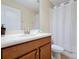 Cozy bathroom showcasing a white vanity, toilet, and shower with curtain in a well-lit space at 8904 Candy Palm Rd, Kissimmee, FL 34747