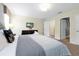 Comfortable bedroom with neutral tones, dresser, TV, and a cozy bed at 8904 Candy Palm Rd, Kissimmee, FL 34747