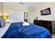 Cozy bedroom with a king-size bed, a TV, and ample closet space at 8904 Candy Palm Rd, Kissimmee, FL 34747