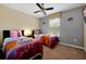 bedroom with two twin beds, themed bedding, and a ceiling fan at 8904 Candy Palm Rd, Kissimmee, FL 34747