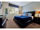 Comfortable bedroom featuring a king-size bed, soft carpet, and a large window at 8904 Candy Palm Rd, Kissimmee, FL 34747