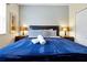 Inviting bedroom showcasing a king-size bed with plush bedding and bedside lamps at 8904 Candy Palm Rd, Kissimmee, FL 34747