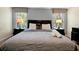 Tastefully decorated bedroom featuring a king-size bed with bedside tables and bright windows at 8904 Candy Palm Rd, Kissimmee, FL 34747