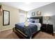 Bedroom featuring a bed with decorative pillows and bedside tables with lamps at 8904 Candy Palm Rd, Kissimmee, FL 34747