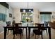 Formal dining room with a modern chandelier and sliding glass doors to the screened lanai at 8904 Candy Palm Rd, Kissimmee, FL 34747