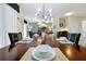 Dining room with table set for a meal, modern lighting, and an open floor plan at 8904 Candy Palm Rd, Kissimmee, FL 34747