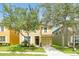 Charming two-story home with well-maintained lawn and mature landscaping at 8904 Candy Palm Rd, Kissimmee, FL 34747