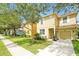 Inviting home featuring lush landscaping, a driveway, and an attached garage at 8904 Candy Palm Rd, Kissimmee, FL 34747