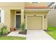 Close up view of a single-car garage and covered front door with bench at 8904 Candy Palm Rd, Kissimmee, FL 34747