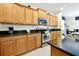 Bright kitchen boasts granite counters, stainless appliances, and ample wood cabinetry at 8904 Candy Palm Rd, Kissimmee, FL 34747