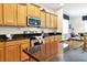 Well-lit kitchen features granite counters, wood cabinets, and stainless steel appliances at 8904 Candy Palm Rd, Kissimmee, FL 34747