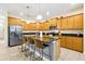 Well-equipped kitchen with granite countertops, stainless steel appliances, and island seating at 8904 Candy Palm Rd, Kissimmee, FL 34747