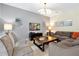 Comfortable living room featuring neutral tones, tile floors, and modern decor at 8904 Candy Palm Rd, Kissimmee, FL 34747