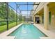 A serene, screened-in pool offers a private outdoor oasis and backyard views at 8904 Candy Palm Rd, Kissimmee, FL 34747
