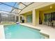 Inviting screened pool area with an outdoor dining set and views of the lanai at 8904 Candy Palm Rd, Kissimmee, FL 34747