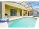 Enclosed pool area with covered lanai, furniture, and view of other screened patios at 8904 Candy Palm Rd, Kissimmee, FL 34747