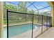 Relaxing screened pool featuring a safety fence, perfect for outdoor enjoyment and peace of mind at 8904 Candy Palm Rd, Kissimmee, FL 34747