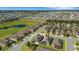Aerial view displaying neighborhood homes with screened patios, landscaping and proximity to community greenspace at 1005 Salamanca Pl, Davenport, FL 33837