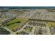 An aerial view of a residential area displaying orderly streets, similar houses and proximity to a nature reserve at 1005 Salamanca Pl, Davenport, FL 33837