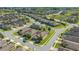 Community aerial view showing well-kept houses, palm trees, and manicured lawns in a modern neighborhood at 1005 Salamanca Pl, Davenport, FL 33837