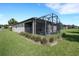 Landscaped backyard featuring an enclosed patio for outdoor enjoyment at 1005 Salamanca Pl, Davenport, FL 33837