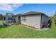 Exterior shot of a cozy home with enclosed patio and expansive grassy yard at 1005 Salamanca Pl, Davenport, FL 33837
