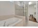 Spa-like bathroom with a soaking tub and separate glass enclosed shower at 1005 Salamanca Pl, Davenport, FL 33837