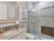 Modern bathroom boasts a shower with glass doors, a vanity, and a mirror at 1005 Salamanca Pl, Davenport, FL 33837